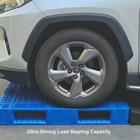 Heavy Duty Plastic Pallet With Breathable Grid Design, 40 X 32 X 6 Inch displayed supporting a car tire to show load capacity.