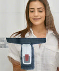 Front view of a black Bosch GlassVAC window vacuum cleaner with gray handle, held by a woman.