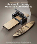 xTool P2S 55W CO2 laser cutter on a desk with wooden boards and a Hawaii-themed surfboard.