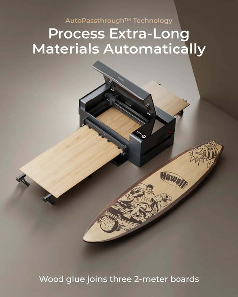 xTool P2S 55W CO2 laser cutter on a desk with wooden boards and a Hawaii-themed surfboard.