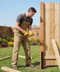 Man using Two Piece Fence Post Repair Kit With Heavy Duty 11 Gauge Steel Anchor Stakes for fixing wooden fence post.