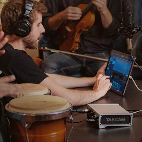 Musician using 10 In 2 Out USB Audio Interface With MIDI And DAW Software For Songwriting, Podcasting, And Home Studio Recording