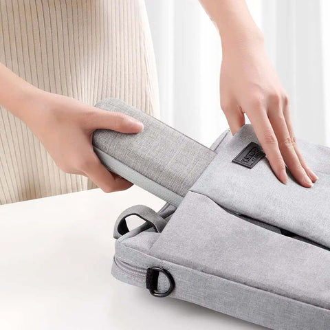 Sleek PU Leather Case Holder For Apple Pencil And Tablet Stylus Pens Featuring Snug Multi Storage Slots For Organizing Charging Cables And Adapters Compact Grey Gear Tote For Your Daily Grind being placed in a grey pouch.
