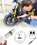 Person using All In One Brake Bleed Kit For Hydraulic Disc Clutches And Car Brakes With 100ml Syringe, Hoses, Adapters on motorcycle