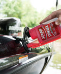 Person pouring Storage Fuel Stabilizer That Keeps Gas Fresh for 24 Months, Prevents Corrosion into a boat's fuel tank, 32 Oz bottle