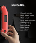 Hand using Professional Meat Thermometer For Grill, Candy, And BBQ With Instant Read, Speedy Half Second Read, mounted on black surface.