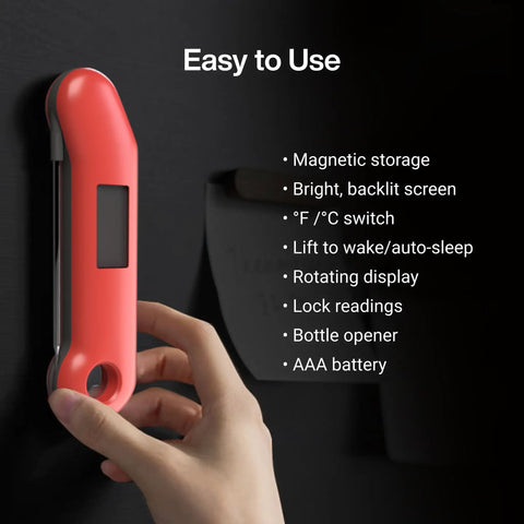 Hand using Professional Meat Thermometer For Grill, Candy, And BBQ With Instant Read, Speedy Half Second Read, mounted on black surface.