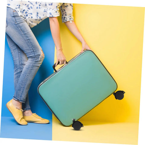 Person carrying a green suitcase with black wheels on blue and yellow background, showcasing stylish travel gear.