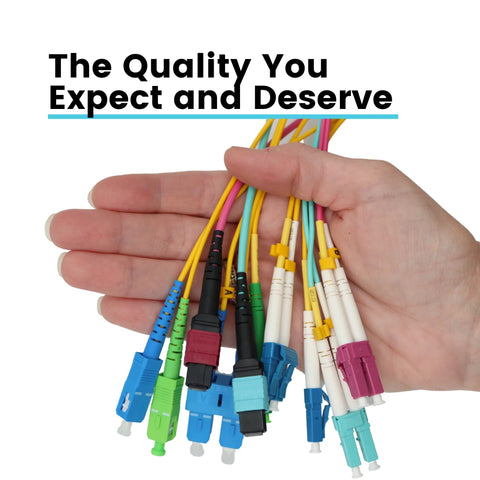 LC-to-LC OM4 fiber patch cables in assorted colors held in a hand (front view).