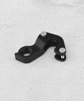 KP158 Aluminum Bike Rear Derailleur Hanger And Double Layer Tail Hook For Road Bikes on a light surface
