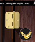 Built Tough Satin Brass Door Hinges 12 Pack 3 1/2 Inch Solid Iron Rounded Corners Pre Drilled Six Holes on dark wood