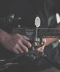 Person adjusting Beefed Up Ambidextrous Turret Rest With Adjustable Swivel for precision target shooting.