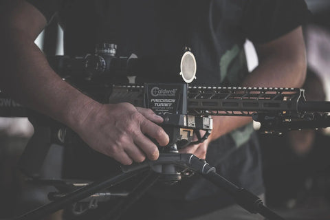Person adjusting Beefed Up Ambidextrous Turret Rest With Adjustable Swivel for precision target shooting.