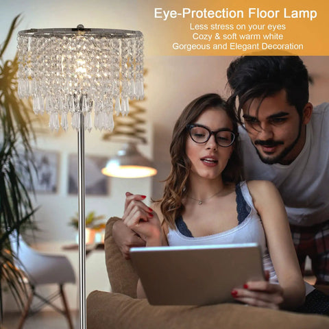 Three Layer K5 Crystal Floor Lamp With Sparkling Triper Layer Shade in living room with couple using tablet
