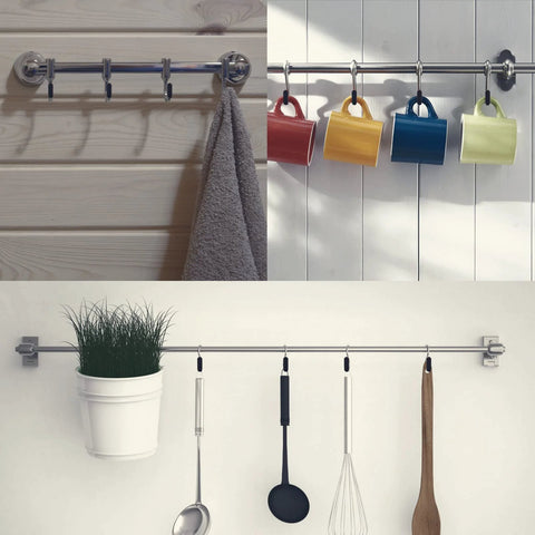 Metal rod with hanging hooks holding towels, cups, utensils, and a plant pot on a light wooden and white ceramic background