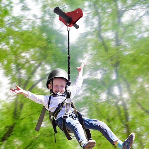 Child using Backyard Zip Line Kit For Kids And Adults, 120 Foot Outdoor Zipline With Swing Seat, Spring Brake And Safety Harness