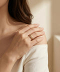 Woman wearing Stackable Pinky Ring For Women Stainless Steel Solitaire Band In Gold Silver Rose Gold And Black Non Tarnish Wedding Ring Comfortable Fit Sizes 3 Through 12 With 1mm And 3mm Options on finger