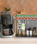 Large Capacity K Cup Holder And Coffee Pod Organizer In Natural Bamboo on kitchen counter beside coffee machine