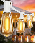 Warm 2200K Outdoor LED String Lights 100Ft With 52 Shatterproof Edison Bulbs glowing at sunset with gazebo backdrop