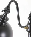 Close-up of sweet matte black steel pharmacy floor lamp featuring matching metal shade and easy rotary switch.