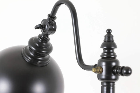 Close-up of sweet matte black steel pharmacy floor lamp featuring matching metal shade and easy rotary switch.