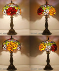 Tiffany Style Stained Glass Table Lamp With Red Rose Shade shown lit, 18-inch tall, antique green bronze finish base, UL Listed.
