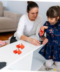 Mother and child using tools alongside Four Pack Ratchet Band Clamp Blocks for woodworking on a DIY furniture project