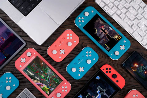 Pocket Sized Lite 2 Bluetooth Controller with motion controls and linear vibration motors in pink and blue next to gaming devices.