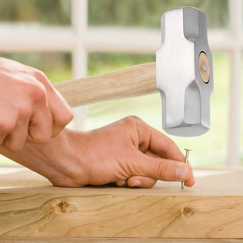 Person using Two Pack 4 Lb Mini Sledge Hammers With Wooden Handles For Demolition on a nail in wood.