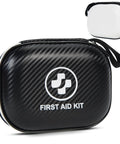 Small black carbon-fiber first aid kit in a hard-shell case with a white logo, plus a small detachable white case.