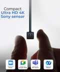 ProMini 4K Eye Contact Webcam with retractable arm shown over fingers, USB camera for laptops, supporting Zoom, Teams, Meet, Webex.