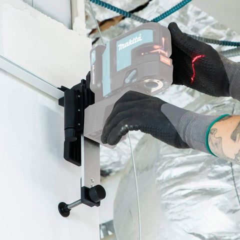 Wall and Ceiling Mount Bracket for Laser Levels in use with a gloved hand adjusting a screw on white metal surface
