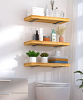 Heavy Duty 12 Pack Hidden L Shelf Brackets 12 Inch Matte Black Iron Floating Wall Mount Hardware For Rustic Industrial Shelving Built Different To Support 100 Lbs Per Pair, showcasing stylish wood shelves with plants and toiletries.