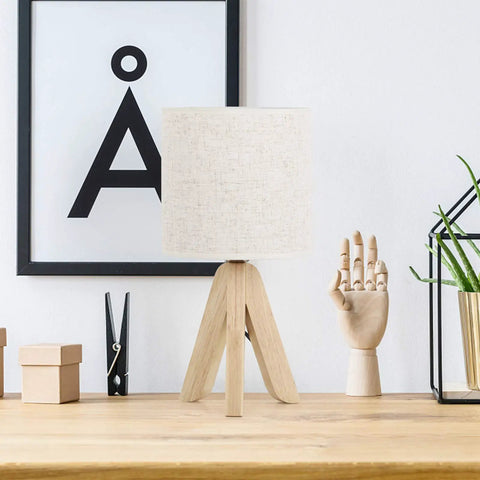 Set Of 2 Cute Wooden Tripod Bedside Lamps With Linen Fabric Shade on wooden desk with decorative items and artwork