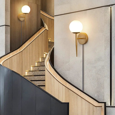 Mid Century Modern Globe Wall Sconce Set Of Two, Brushed Brass Finish With Frosted White Glass Globes on stairwell