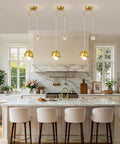IPEDWO 2-Light Modern Gold Pendant Lights, Light Fixture for Kitchen Island hanging over a kitchen island with marble countertop.