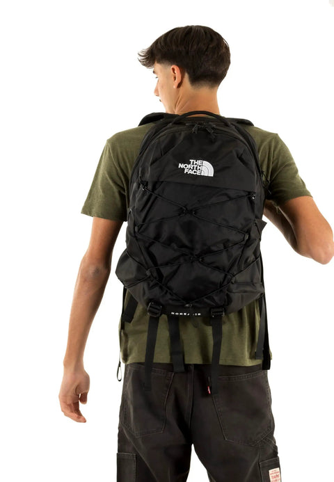 Man wearing Borealis Commuter Laptop Backpack With Water Repellent Fabric Laptop Sleeve And Large Main Compartment Ergonomic FlexVent Support For Daily Commute And School Your Everyday Tech Gear Carry Bag, black color