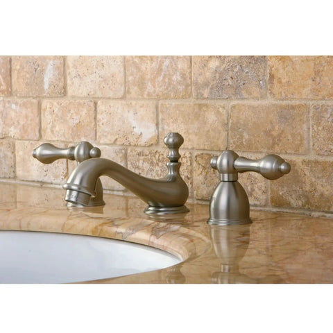 Model KS3952AL restoration mini widespread lavatory faucet with metal lever handles in a polished brass finish, installed on sink
