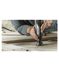 Close-up of Smooth Operator 12V Cordless Rotary Tool Bundle With 160 Piece Nifty Accessory Pack, cutting wood surface.