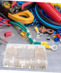 Nylon Round Spacer Nut Kit 150 Pcs Insulated Washers With Labeled Storage Case on workshop table with tools and wires.