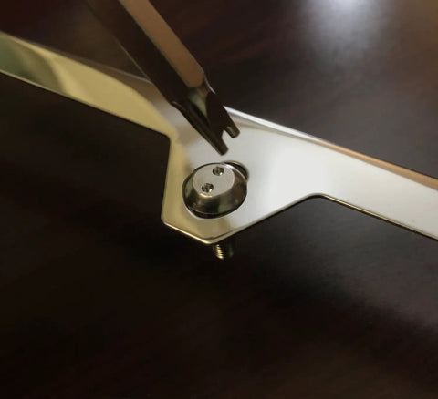 Lock Down Your Rolling Rig With Stainless Steel License Plate Screws Crafted Into Rust Proof Anti Theft Bolts Mounted With Glossy Chrome Caps For A Snug Fit And Zero Hassle Install close-up of chrome bolt and screw being fitted.