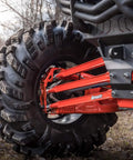 Heavy Duty Boxed Rear Radius Arms Kit For Can Am Maverick X3 72 Inch Turbo X RC MR RS MAX - Complete 6 Rod Set In Red With Reinforced Pivot Joints And Five Eighths Heim Joints For Strength And 100 Percent Fitment Guaranteed. rear suspension with red arms and large off-road tire