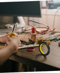 One Roll Blackout Tape For Windows That Blocks LED Light And Dims Screens With Heavy Duty Adhesive on a wooden desk setup
