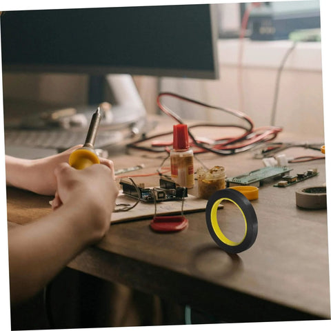 One Roll Blackout Tape For Windows That Blocks LED Light And Dims Screens With Heavy Duty Adhesive on a wooden desk setup