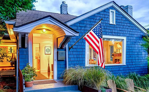 3x5 US Flag Pole Kit With Heavy Duty 5ft Tangle Free Flagpole And Weather Resistant Embroidered American Flag on blue house porch