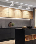 Modern kitchen with Three Color Temperature 20W LED Track Lighting Heads Dimmable Flicker Free 36 Degree Beam 2000 Lumen Per Head CRI90 Plus 3 Pack for Accent Kitchen Artwork and Retail Linear Track Lighting H Type installed on ceiling, illuminating wooden cabinets and black countertop.