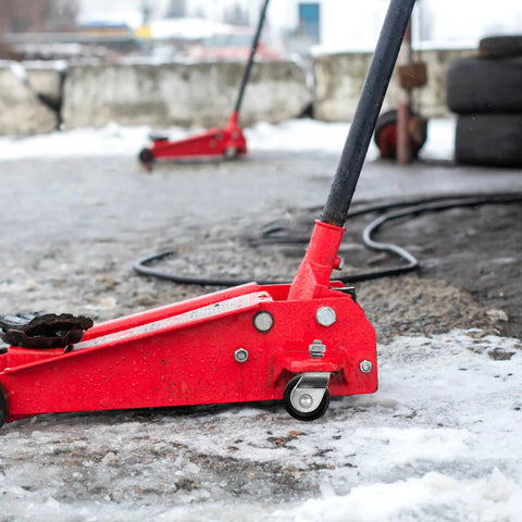 Red hydraulic floor jack with Universal Hydraulic Floor Jack Caster Wheel Replacement 2.75x1.96x1.57 In Swivel Wheel visible outdoors