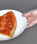 Close-up of hand wearing clear embossed poly glove holding plate with pizza slice, demonstrating textured grip for food handling.