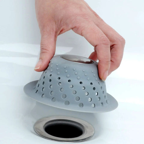 Hand placing Over Drain Dome Hair Catcher Protector For Shower And Tub Keeps Water Flowing While Trapping Hair No Clog Drama over drain