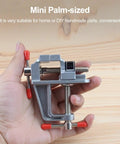 Built Tough Mini Table Vise Crafted From Premium Aluminum Alloy Featuring Wide Flat Jaws For A Killer Hold in a palm-sized size.